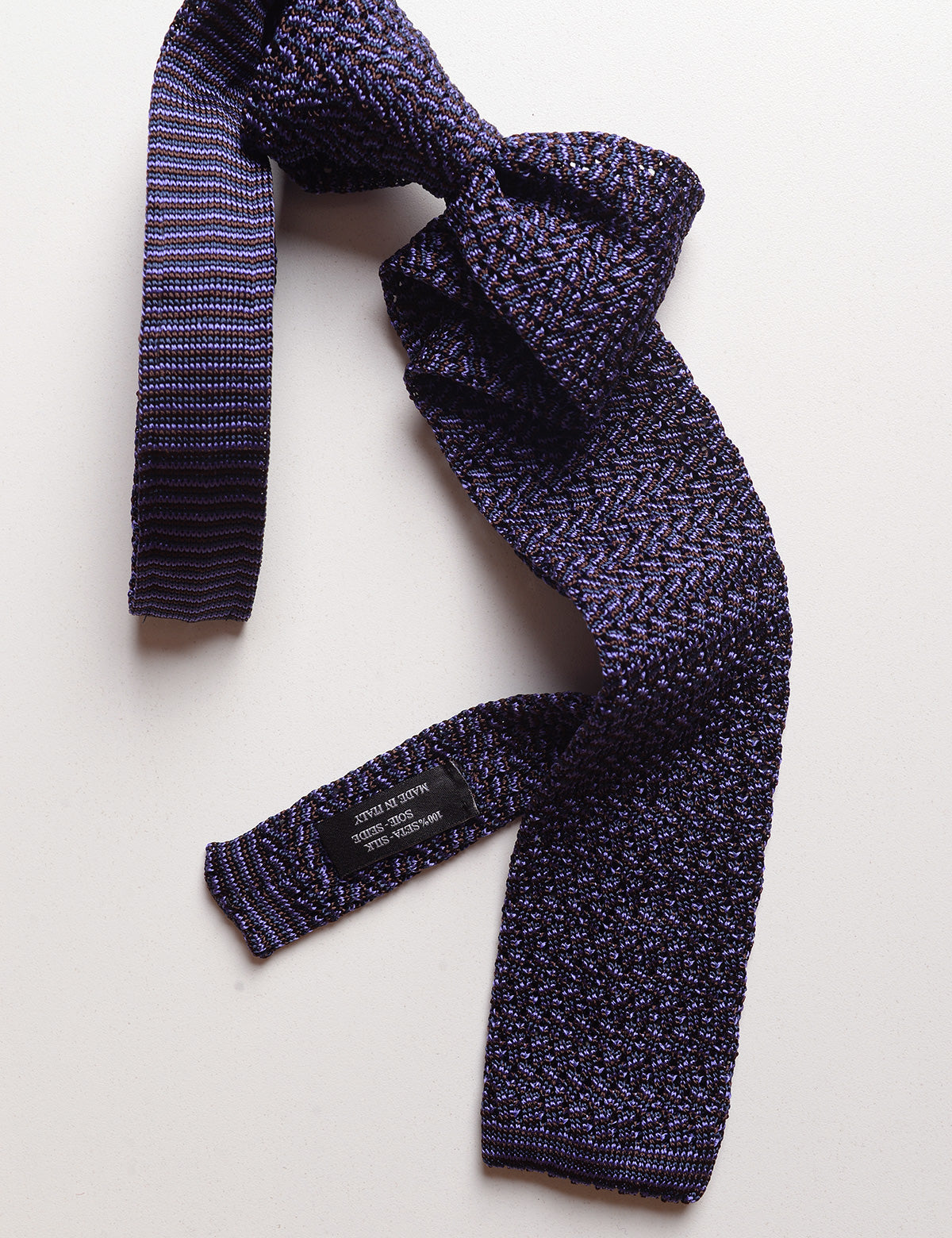 Knit and label detail of Micro Pattern Silk Knit Tie - Amethyst