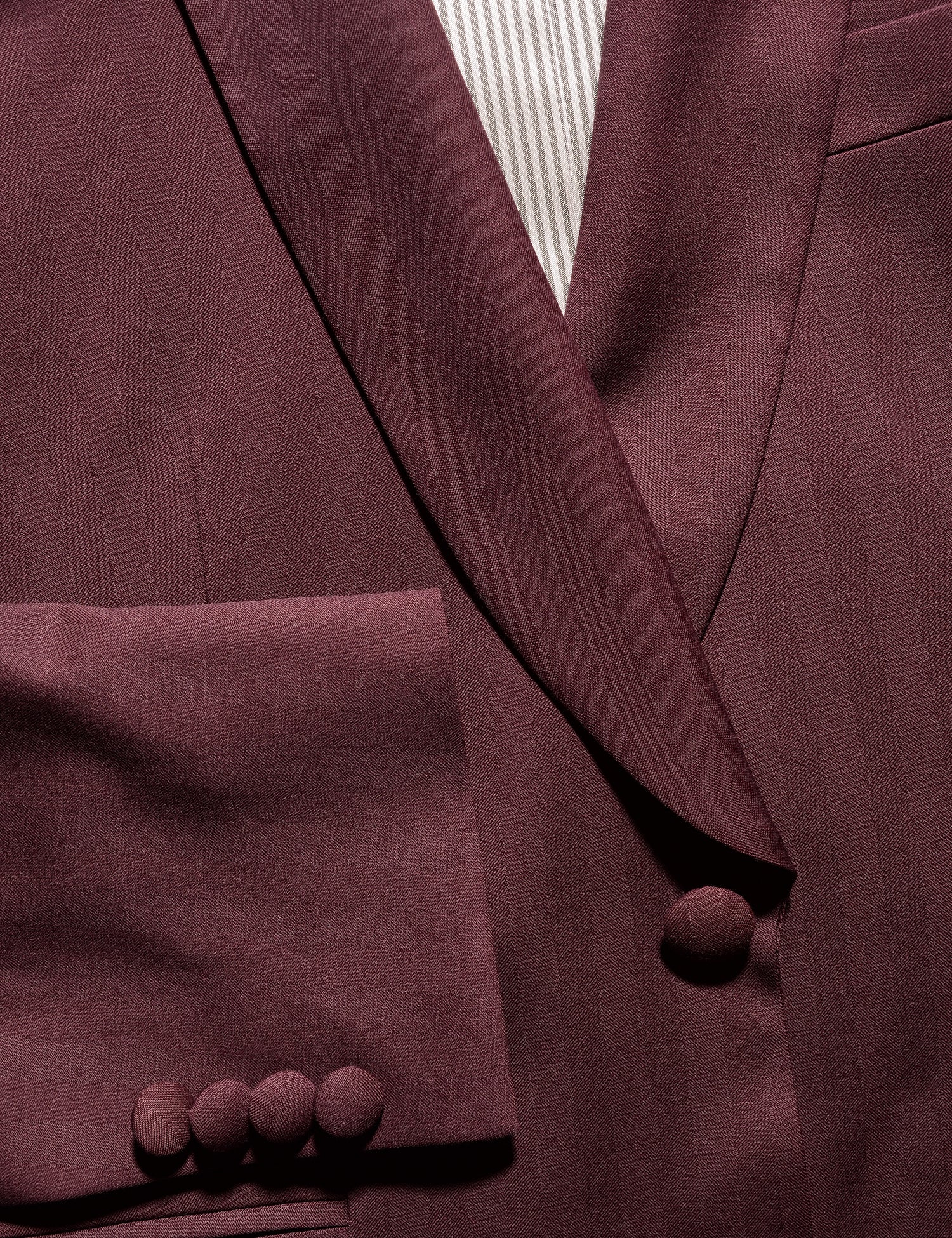 Detail shot of Brooklyn Tailors BKT50 Shawl Collar Dinner Jacket in Wool Herringbone - Syrah showing cuff, lapel, covered buttons, lining and fabric texture