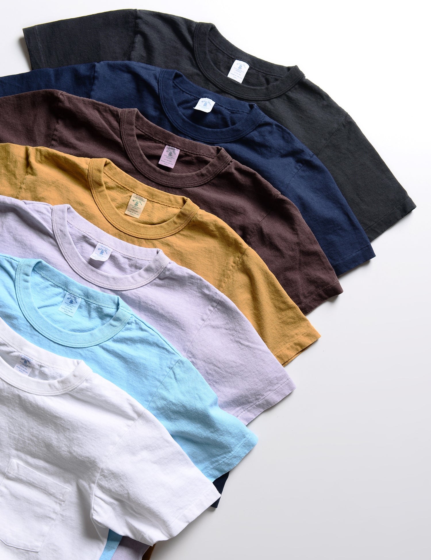 Detail of several colors of Velva Sheen Pigment Pocket Tees