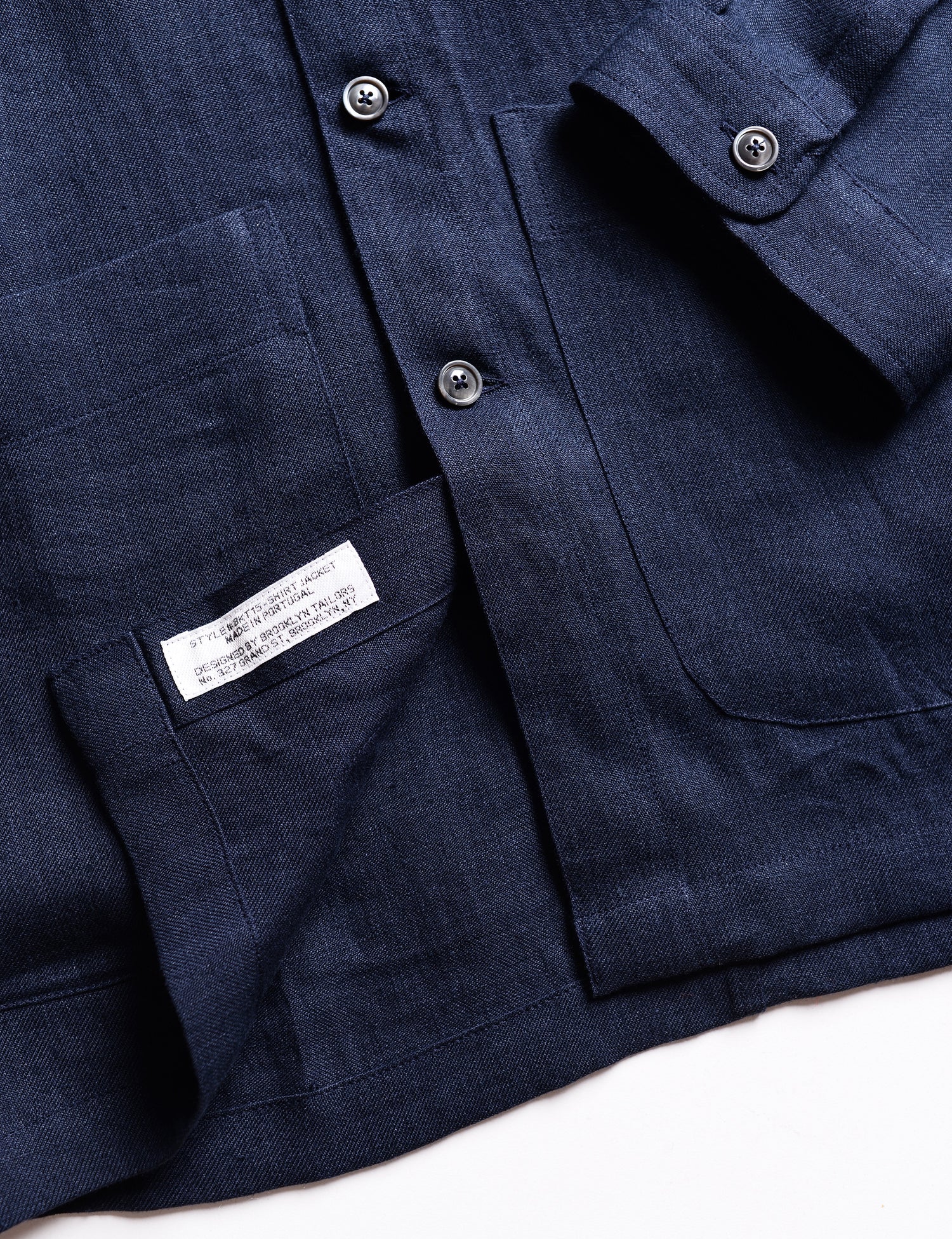 Detail shot of hem and interior labeling of Brooklyn Tailors BKT15 Shirt Jacket in Linen Twill - Salerno Blue