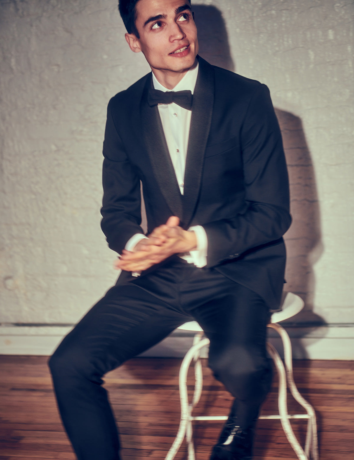On-body shot of BKT50 Tuxedo Trouser in Super 110s - Black with Grosgrain Stripe. Model is wearing the trousers with matching tuxedo jacket, white tuxedo shirt, and black bowtie
