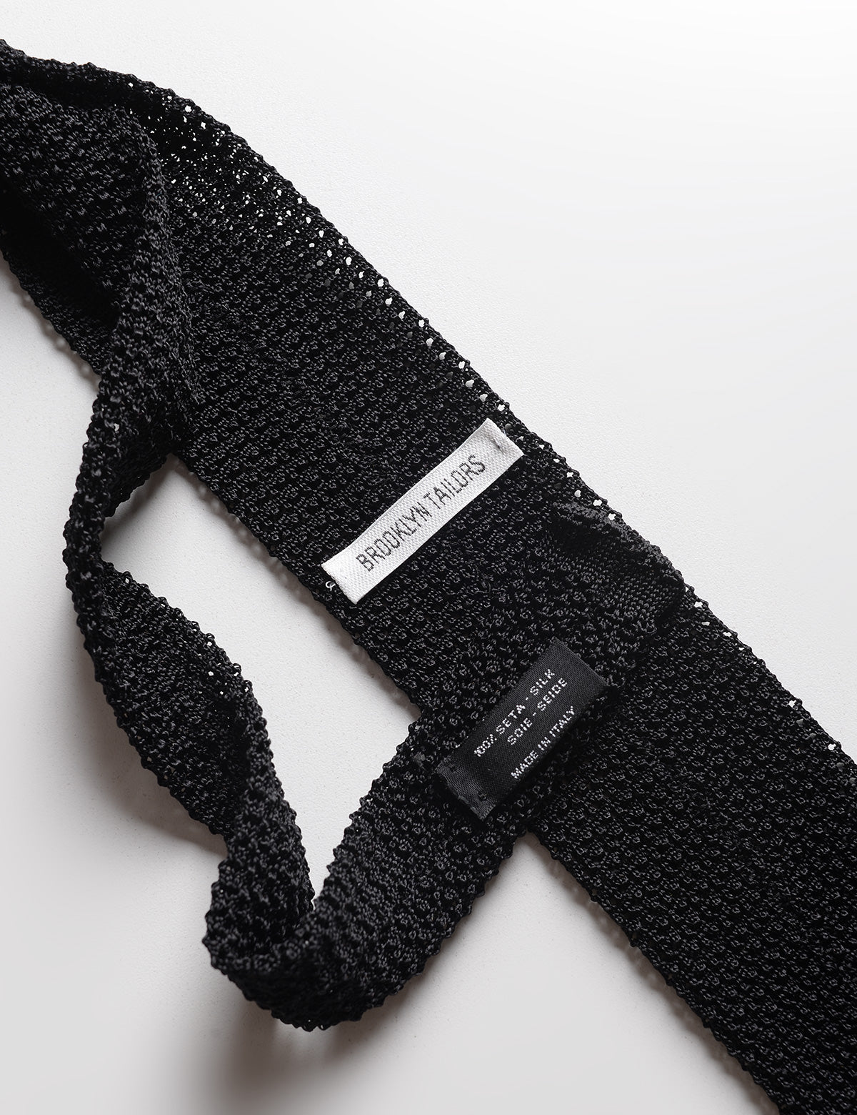 Detail of labels and knit of Italian Silk Knit Tie - Black
