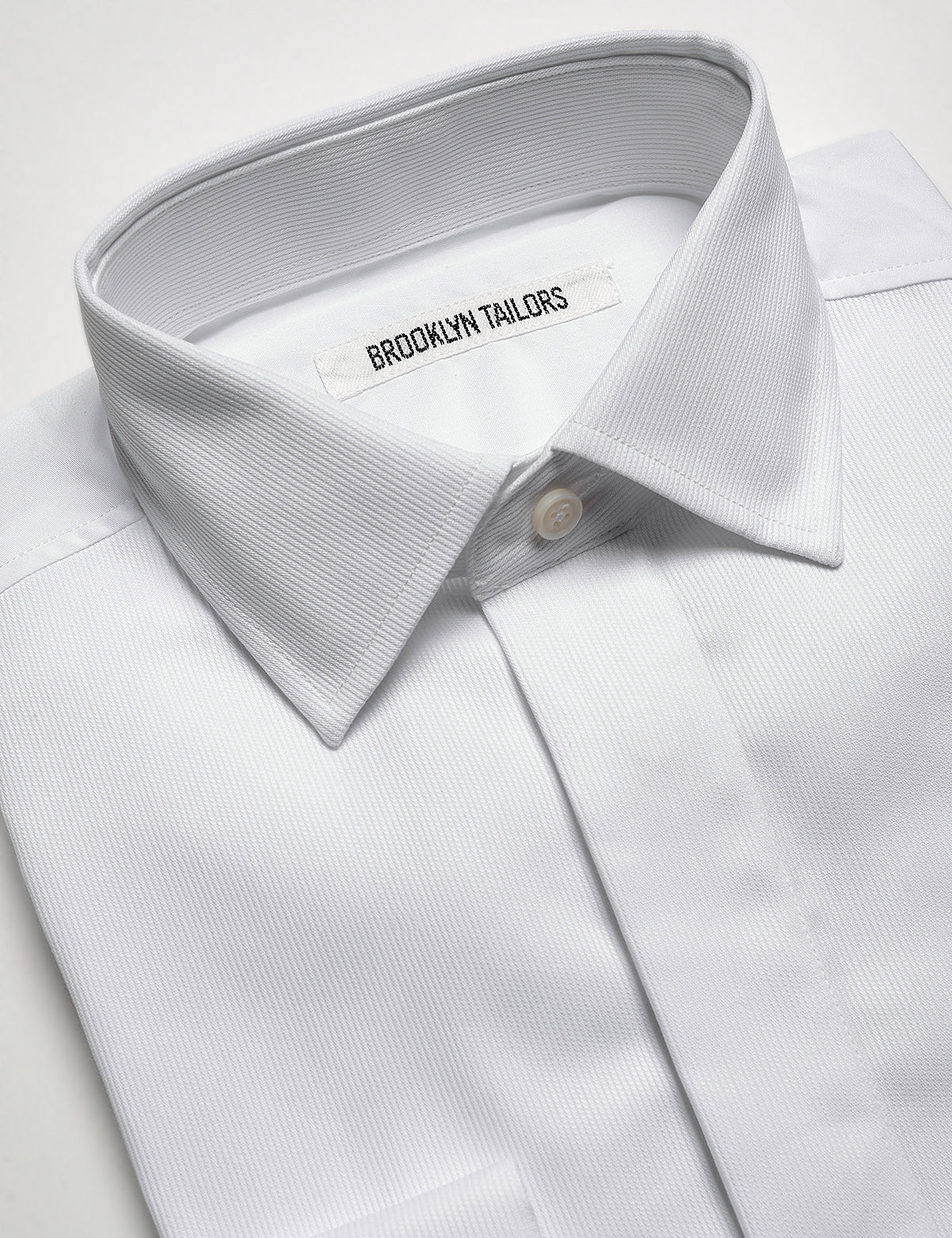 Detail of Brooklyn Tailors French Cuff Tuxedo Shirt With Covered Buttons - Bar Pique showing collar and fabric texture