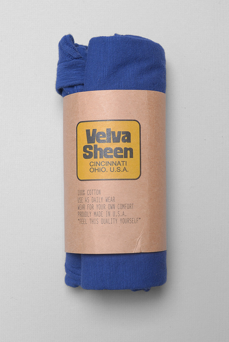 Photo of Velva Sheen Crewneck T-Shirt in Vintage Blue rolled in its paper packaging