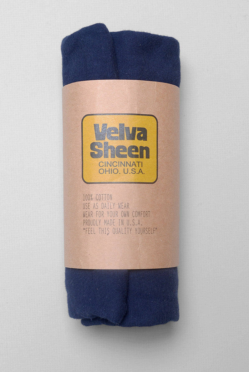 Photo of Velva Sheen Crewneck T-Shirt in Navy rolled in its paper packaging