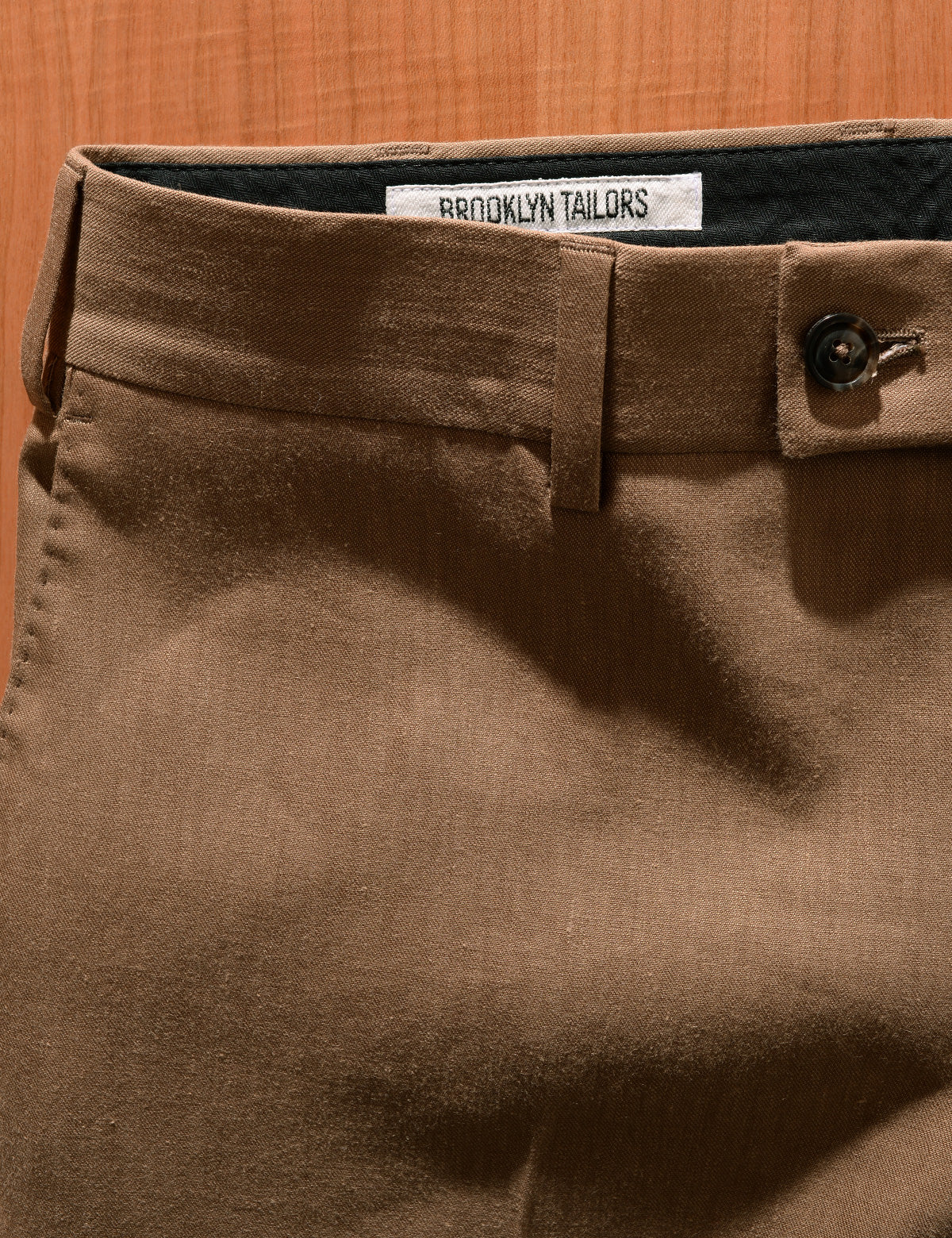 Close up of BKT50 Tailored Trousers in Wool Linen - Sahara front button closure